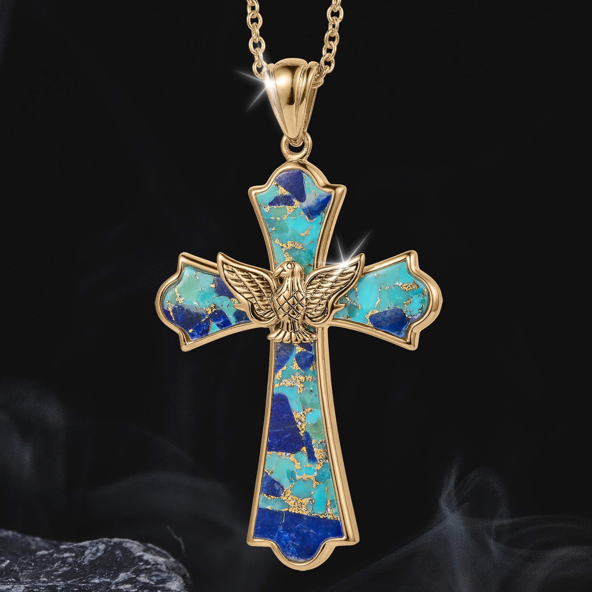 Wings Of Freedom Collection pendant featuring a gold cross inlaid with turquoise and blue stone accents, adorned with a detailed gold eagle centerpiece on a gold chain.