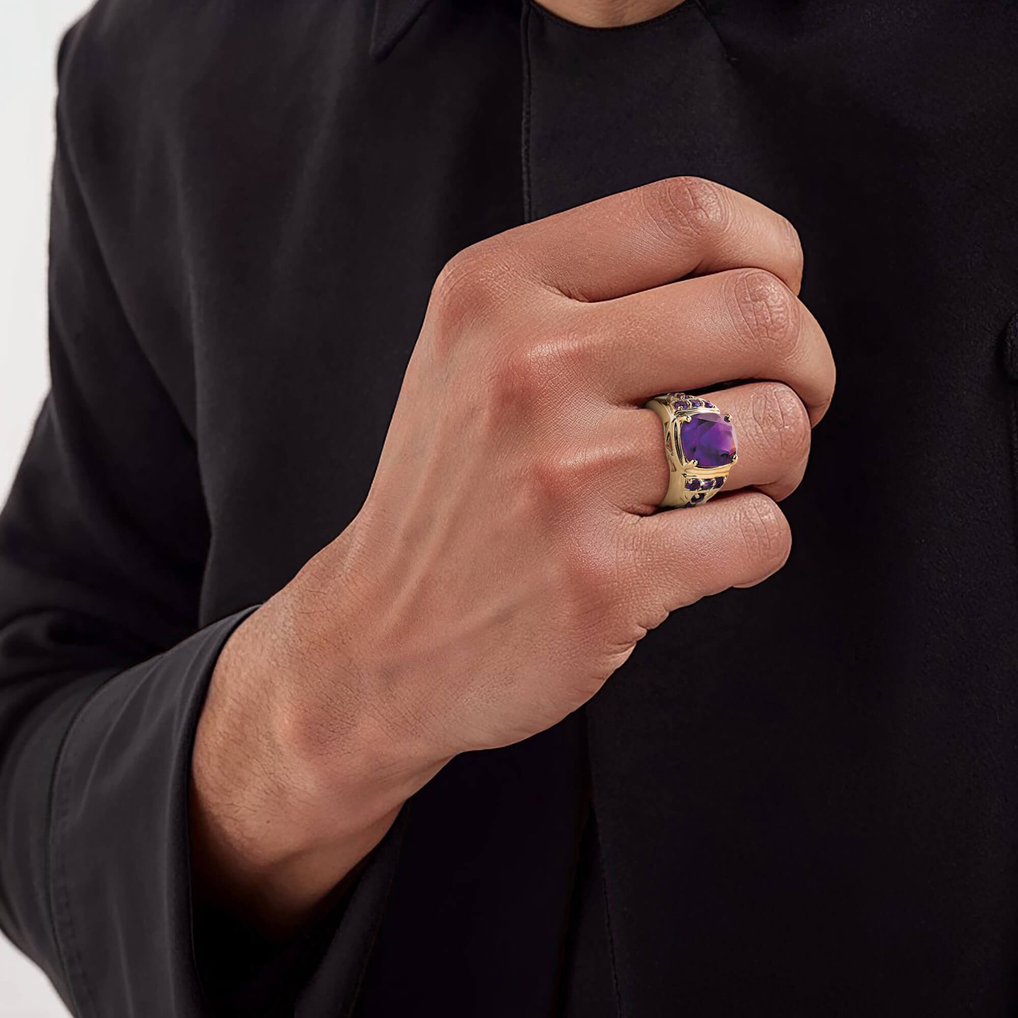 Majestic Amethyst Men's Ring featuring a bold purple amethyst gemstone set in sterling silver with gold plating, showcased on a male hand wearing a black long-sleeve garment.