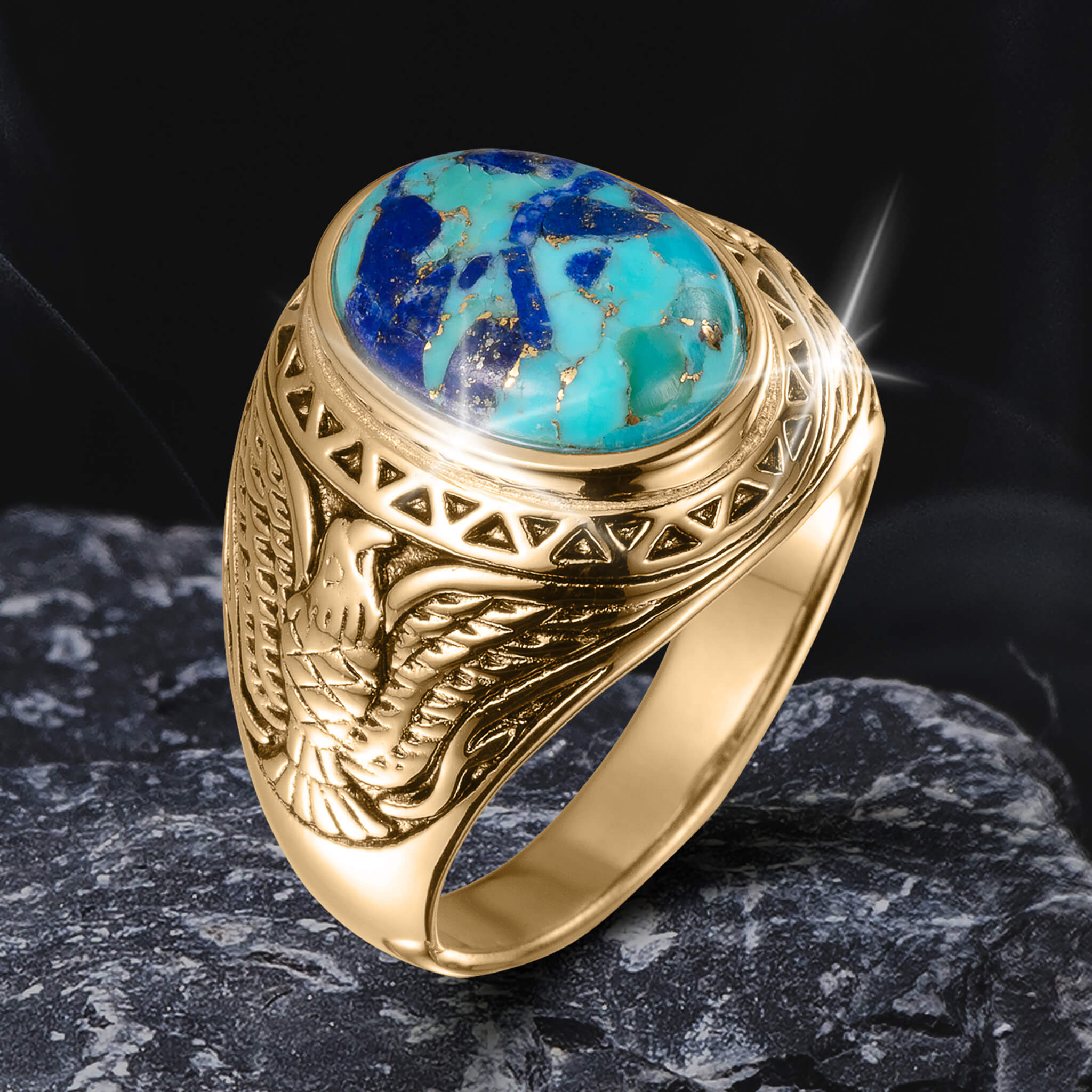 Gold ring from the Wings Of Freedom Collection featuring intricate eagle engraving and a polished blue-green stone centerpiece, symbolizing strength and elegance.
