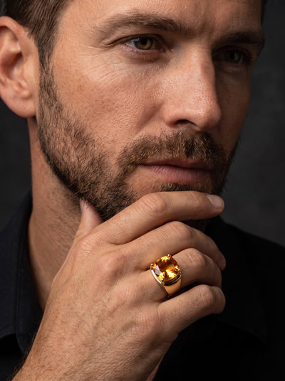 Citrine Royale Ring featuring a glowing golden citrine gemstone worn by a bearded man in a refined close up portrait