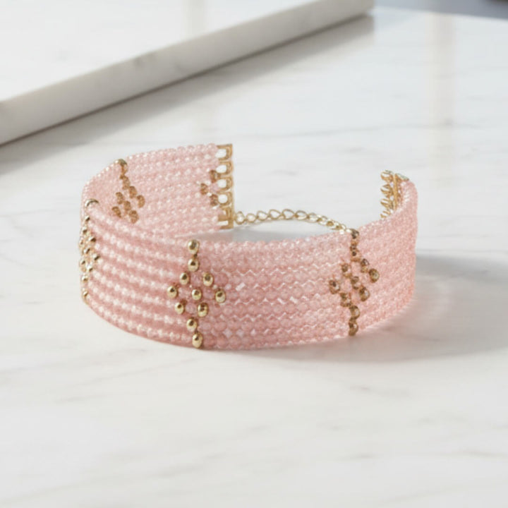 Rosa Cascade Bracelet featuring delicate pink gems with rose gold plating, designed for a feminine and elegant look, set on a white marble surface.