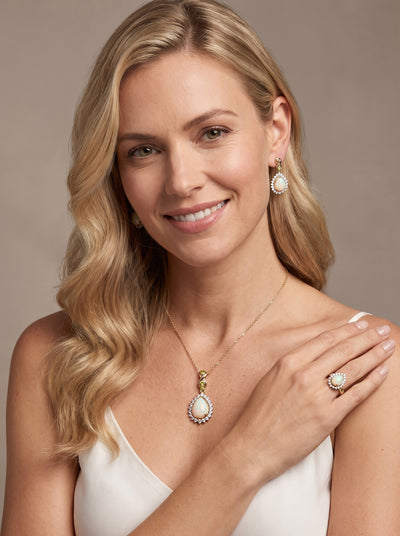 Opal Dew Drop Collection Set featuring opal pendant necklace earrings and ring jewelry modeled by a smiling woman Up To 75% Off Retail