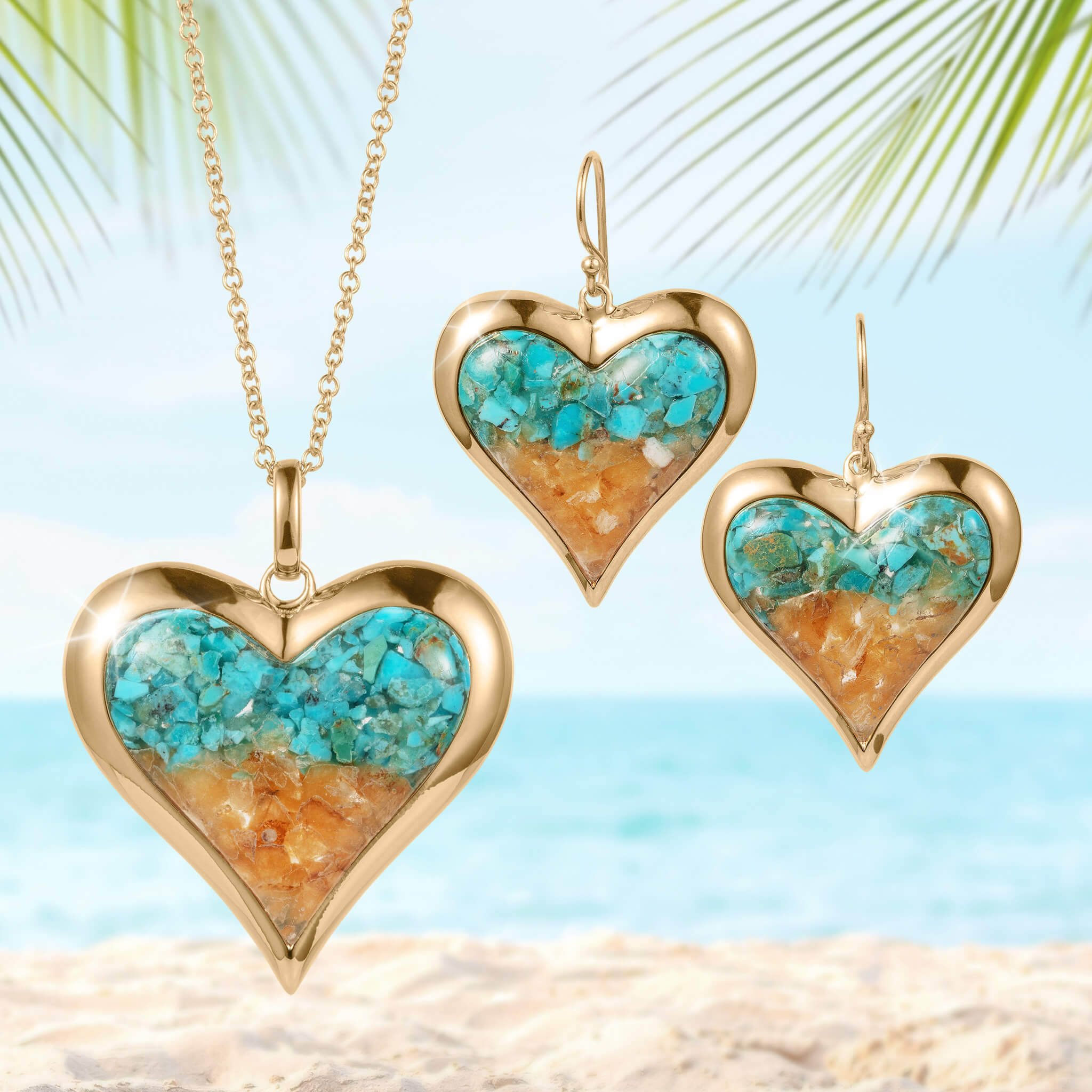 Sunlit Shore Heart Collection gold-tone heart-shaped necklace and matching earrings with turquoise and sandy-colored inlay, displayed on a beach background.