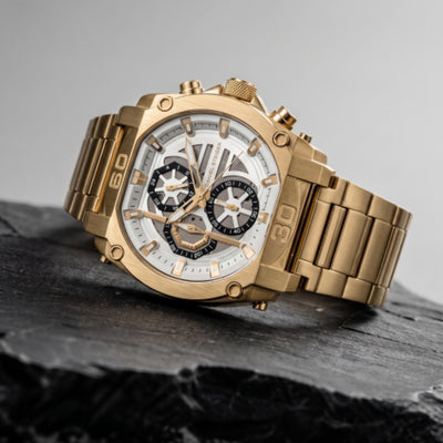 Close-up of a luxurious Titan Gold Men's Watch with a gold metal bracelet and detailed white and black chronograph dial, showcased on a dark textured surface with Up To 75% Off Retail. Daniel Steiger Titan Gold Men's Watch