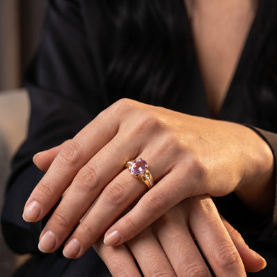 Cherished 10K Gold Amethyst Ring with a polished purple amethyst gemstone worn on a hand showcasing elegant jewelry styling and radiant gold detail