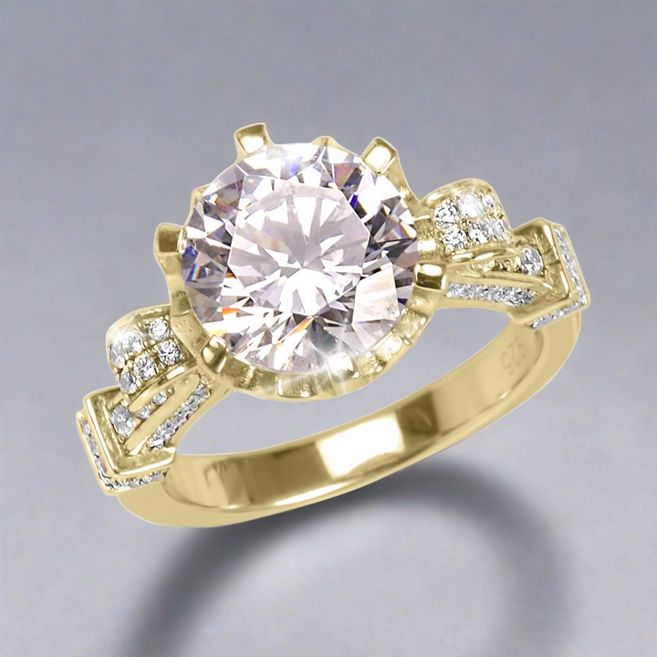 Baroque Ring featuring a large round center stone set in gold-plated sterling silver with intricate side detailing and small sparkling accent stones, designed for women’s jewelry.