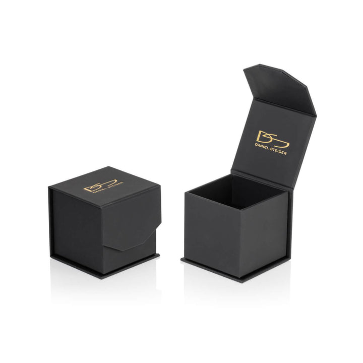 Two black jewelry boxes with gold DS Daniel Steiger logos, one closed and one open, designed to hold the Oliva Glisten Ring.