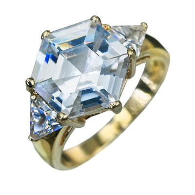 Hexa Ring featuring a sterling silver band plated in gold with a large hexagonal clear gemstone centerpiece flanked by two smaller triangular clear stones, designed for female jewelry enthusiasts.