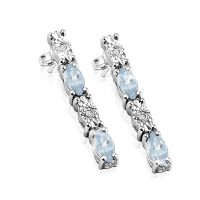 Navette Topaz Earrings featuring sterling silver with rhodium plating, showcasing a feminine design with light blue stones and sparkling clear accents for elegant jewelry styling.