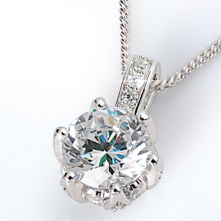 Lotus Pendant featuring a sparkling round gemstone set in sterling silver with rhodium plating, designed for women, hanging from a delicate chain necklace.