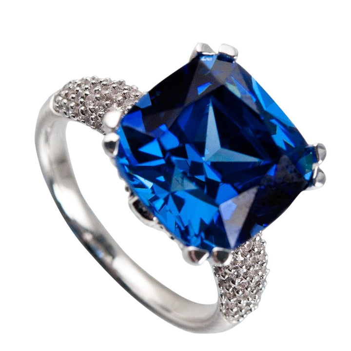 Hope Ring featuring a large cushion-cut blue gemstone set in sterling silver with rhodium plating, designed as elegant female jewelry ring.
