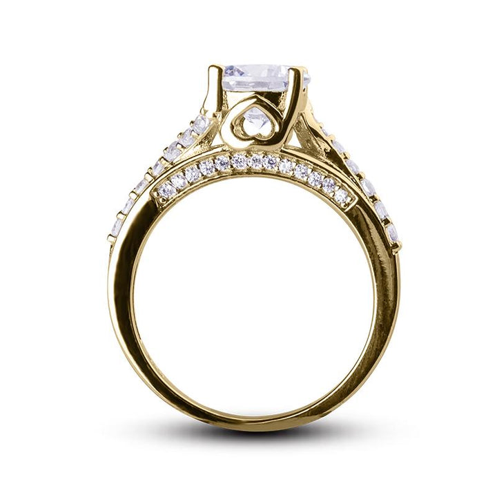 Oliva Glisten Ring in sterling silver with gold plating, featuring a central rectangular gemstone and small round crystals along the band, designed for women’s jewelry.