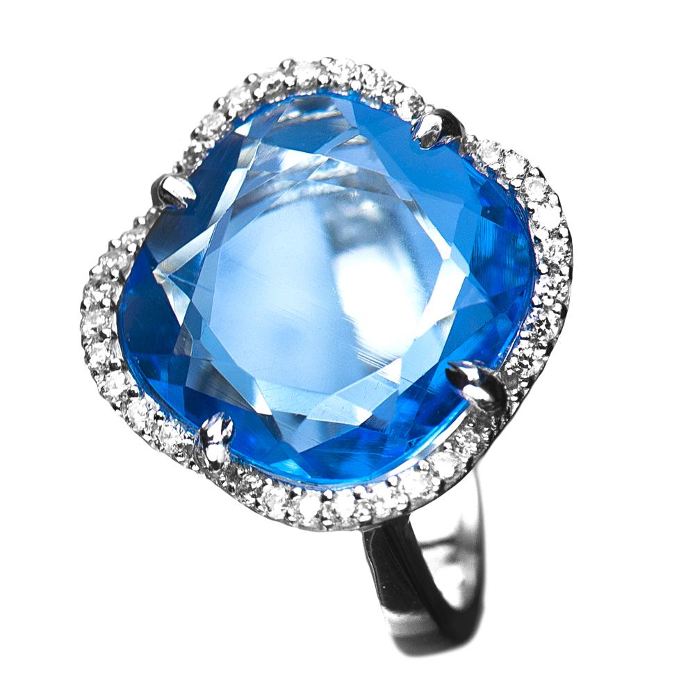 Silver Ice Lake Ring for female featuring a large blue gemstone surrounded by smaller clear stones, crafted with sterling silver and rhodium plating.