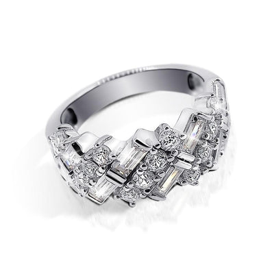 Elegant Ascot Ring for female in sterling silver with rhodium plating, featuring an intricate design with sparkling baguette and round-cut stones, perfect jewelry choice.
