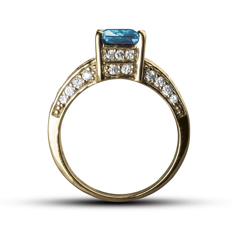 Sonora Dress Ring featuring a sterling silver band with a rectangular blue gemstone centerpiece and surrounded by small sparkling stones, designed for women’s jewelry.