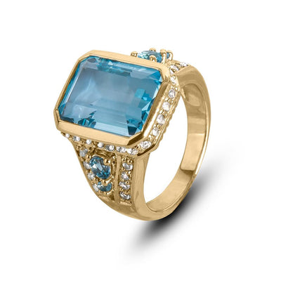 Bermuda Blue Topaz Ring featuring a large rectangular blue topaz stone set in sterling silver with gold plating and accented with small clear crystals, designed for women.