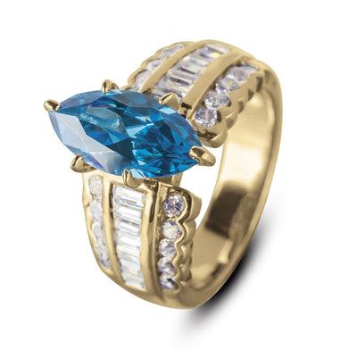 Carman Marquise Ring in gold-plated stainless steel featuring a large marquise-cut blue gemstone center and rows of clear baguette and round-cut accents, designed for women’s jewelry.