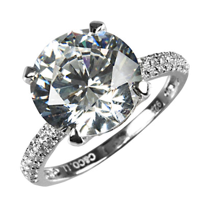 Supernova Ring featuring a large round brilliant stone set in rhodium-plated sterling silver band with smaller accent stones, designed for female jewelry enthusiasts.