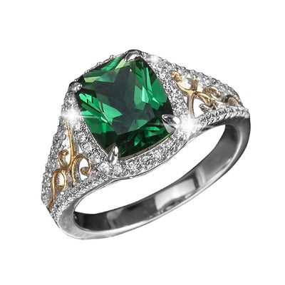 Aurora Ring featuring a sterling silver two-tone design with a large green gemstone centerpiece surrounded by sparkling small clear stones and intricate gold accents.