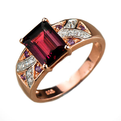 Carnation Garnet Ring featuring a sterling silver band with rose gold plating, adorned with a rectangular garnet center stone and sparkling accent gemstones, designed for women.