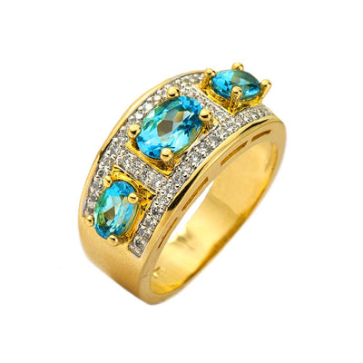 Mayfair Ring featuring sterling silver with gold plating, adorned with three blue gemstones and surrounded by small clear crystals, designed for females.