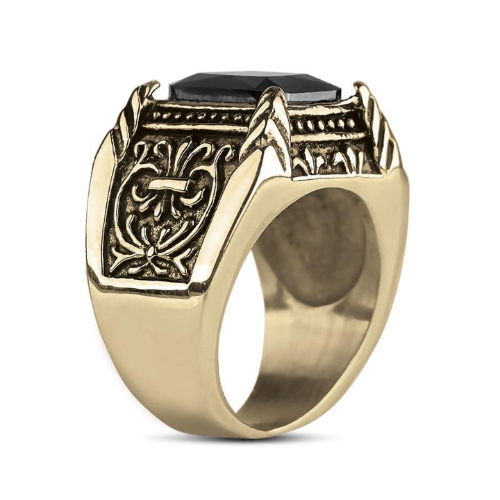 Caesar Nero Ring crafted in gold-plated stainless steel featuring intricate engravings and a prominent black gemstone, a bold statement piece of men's jewelry.