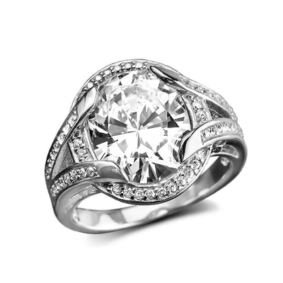 Valentina Ring featuring a large sparkling centerpiece surrounded by a sterling silver band with intricate gold plating and encrusted with smaller clear gemstones, designed for women.
