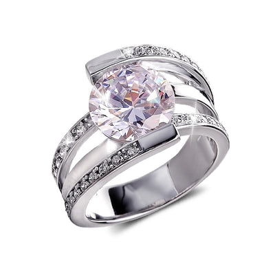 Rodela Rhodium Ring featuring a sterling silver band with rhodium plating, adorned with a large central clear gemstone and smaller accent stones, designed for women.