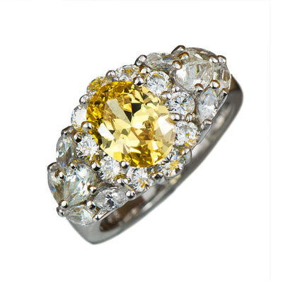 Rhodium Canaria Ring featuring a sterling silver band plated with rhodium, adorned with a central yellow gemstone surrounded by clear stones in an elegant design for women.