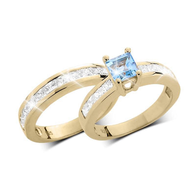 Maria Duo Blue Topaz Bridal Ring featuring a sterling silver band with gold plating, elegant blue topaz center stone, and sparkling clear accents, designed for women.