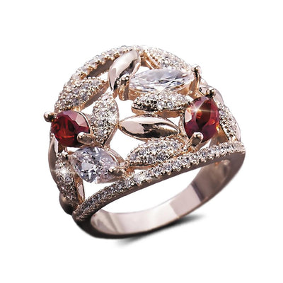 Fever Rose Ring crafted in sterling silver with rose gold plating, featuring intricate leaf designs adorned with clear and red gemstones, a stunning female jewelry piece.