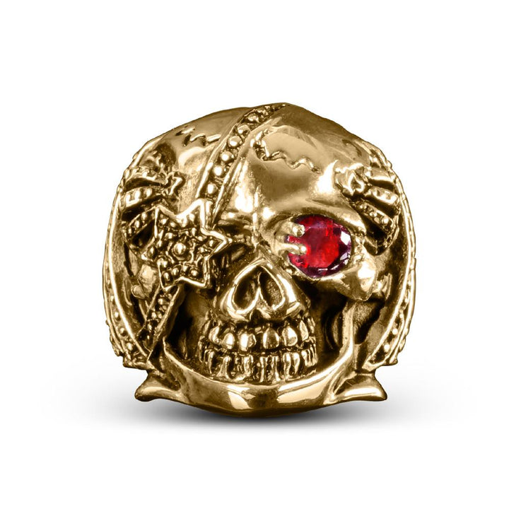 Riotous Skull Ring in gold plated stainless steel featuring a detailed skull design with a red gemstone eye, perfect bold jewelry for men.