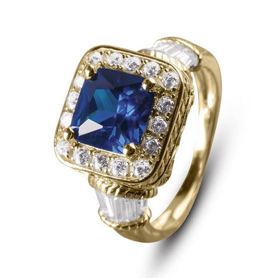 Princesa Azul Ring featuring a large blue gemstone surrounded by clear stones set in sterling silver with elegant detailing, designed for women’s jewelry collections.