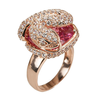 Snake Charmer Ring featuring a two-tone sterling silver design with sparkling stones forming a coiled snake around a vibrant pink gemstone, elegant female jewelry piece.