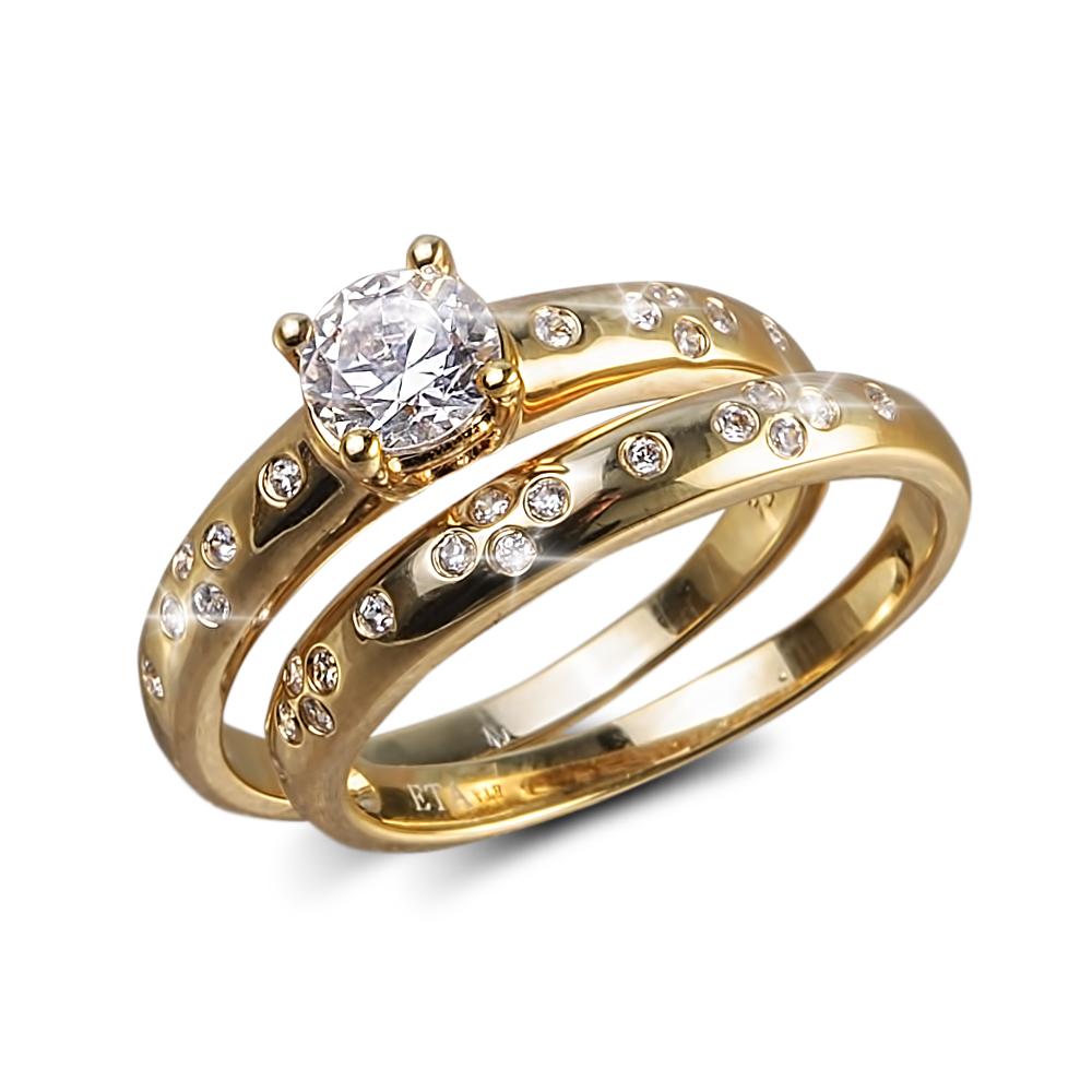 Stardust Ring featuring sterling silver base with gold plating, designed for women, showcasing a sparkling round center gemstone and accent diamonds on two intertwined bands.