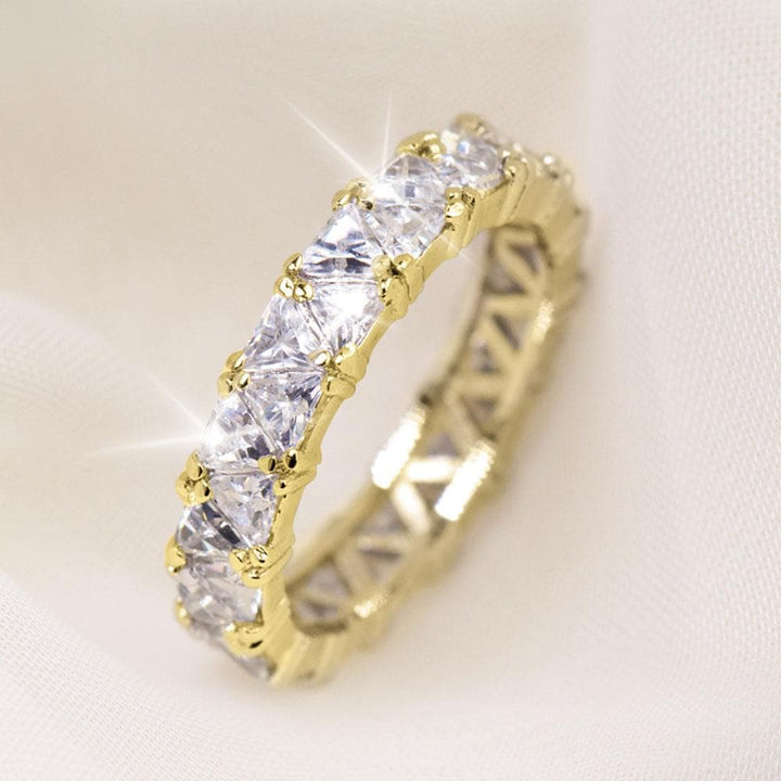 Gold Triana Ring featuring a sterling silver band plated in gold, adorned with multiple sparkling clear gemstones for an elegant female jewelry piece.